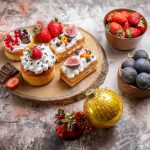 front-view-delicious-cakes-with-fresh-fruits-light-background-christmas-cake-dessert-color-biscuits (1)
